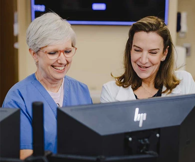 Two woman working on computer